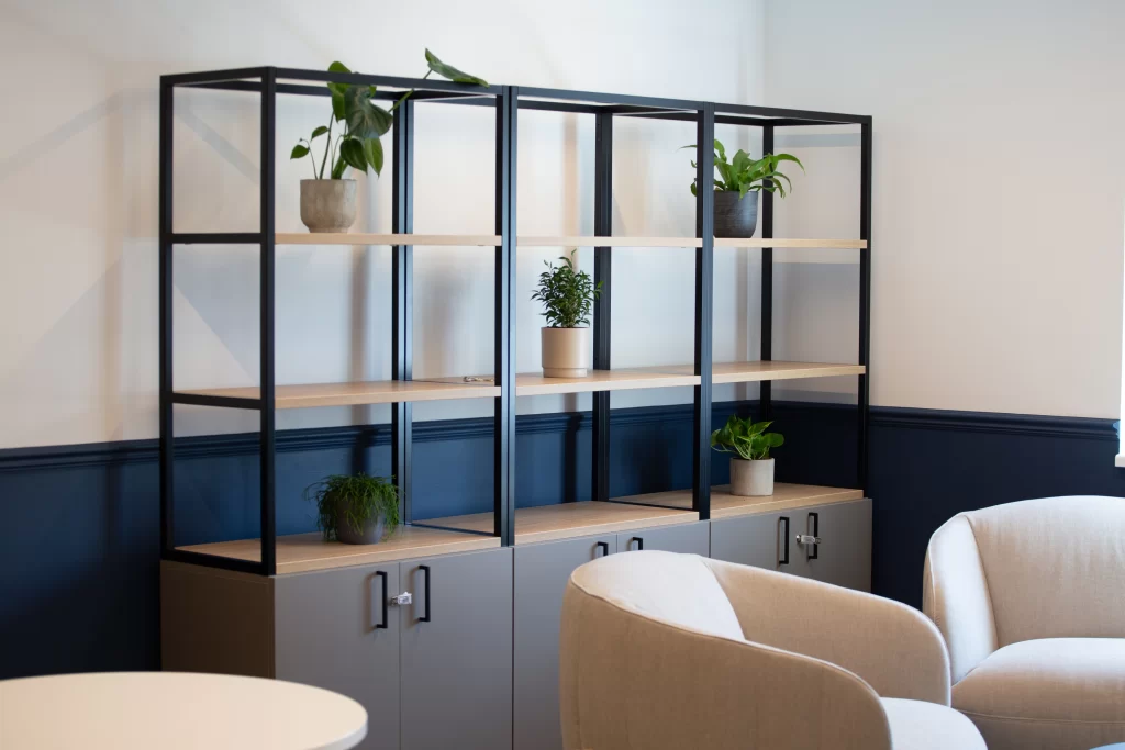 three live plants in workspace open plan shelving