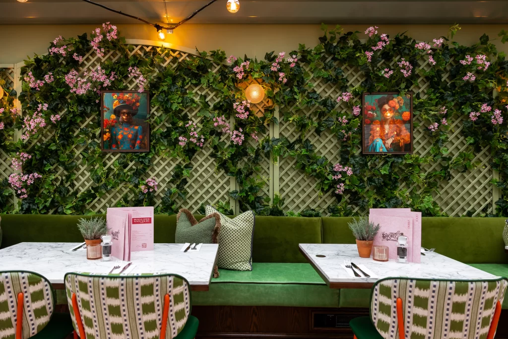 trellis with artificial ivy and pink flowers by i want plants