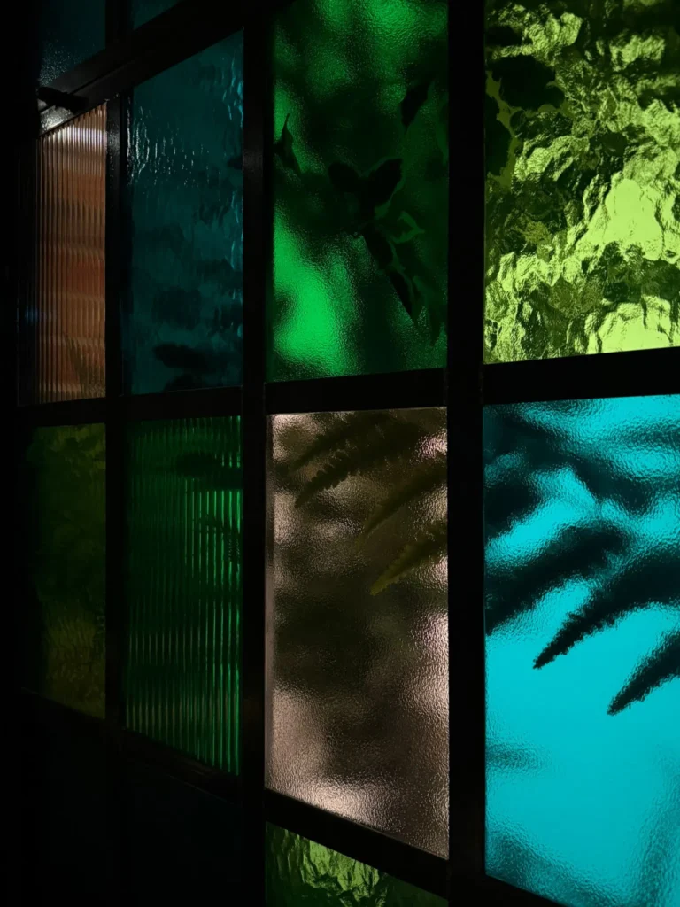 Treehouse Hotel Manchester Plant displays behind tinted glass window